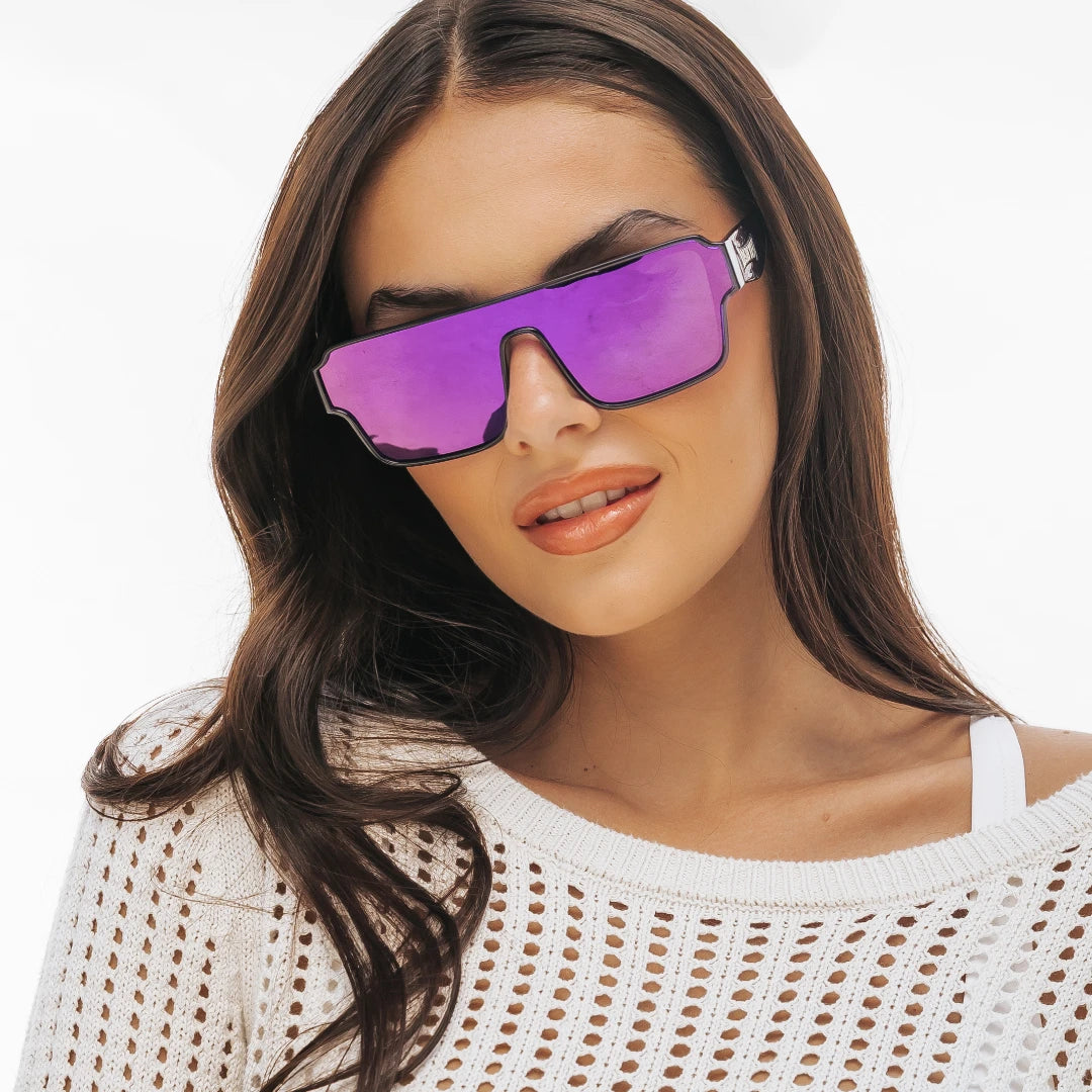 Woman wearing purple Zeus Omega sunglasses by LosReyes with a white background