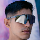 Lifestyle photo of LosReyes Prime Galaxy Moon wraparound sunglasses paired with modern streetwear, reflecting bold mirrored lenses and lightweight clear frames for active fashion.