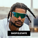 Man wearing reflective LosReyes blue raz sunglasses with 'Shop Elevate' text overlay