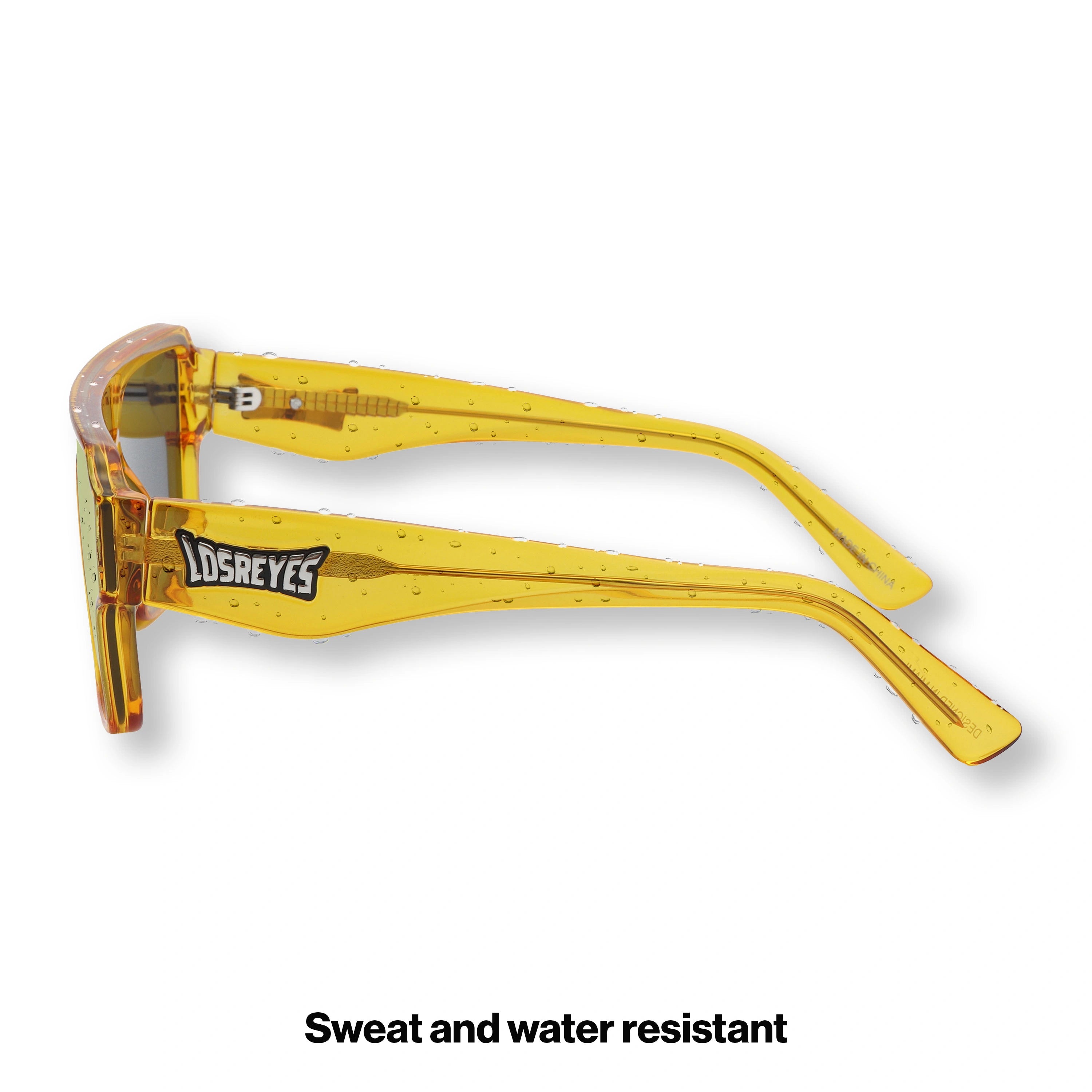 Side profile of LosReyes Omega Yellow athletic sunglasses featuring a bold amber temple design, reinforced arms, and a secure sport fit ideal for intense activity.