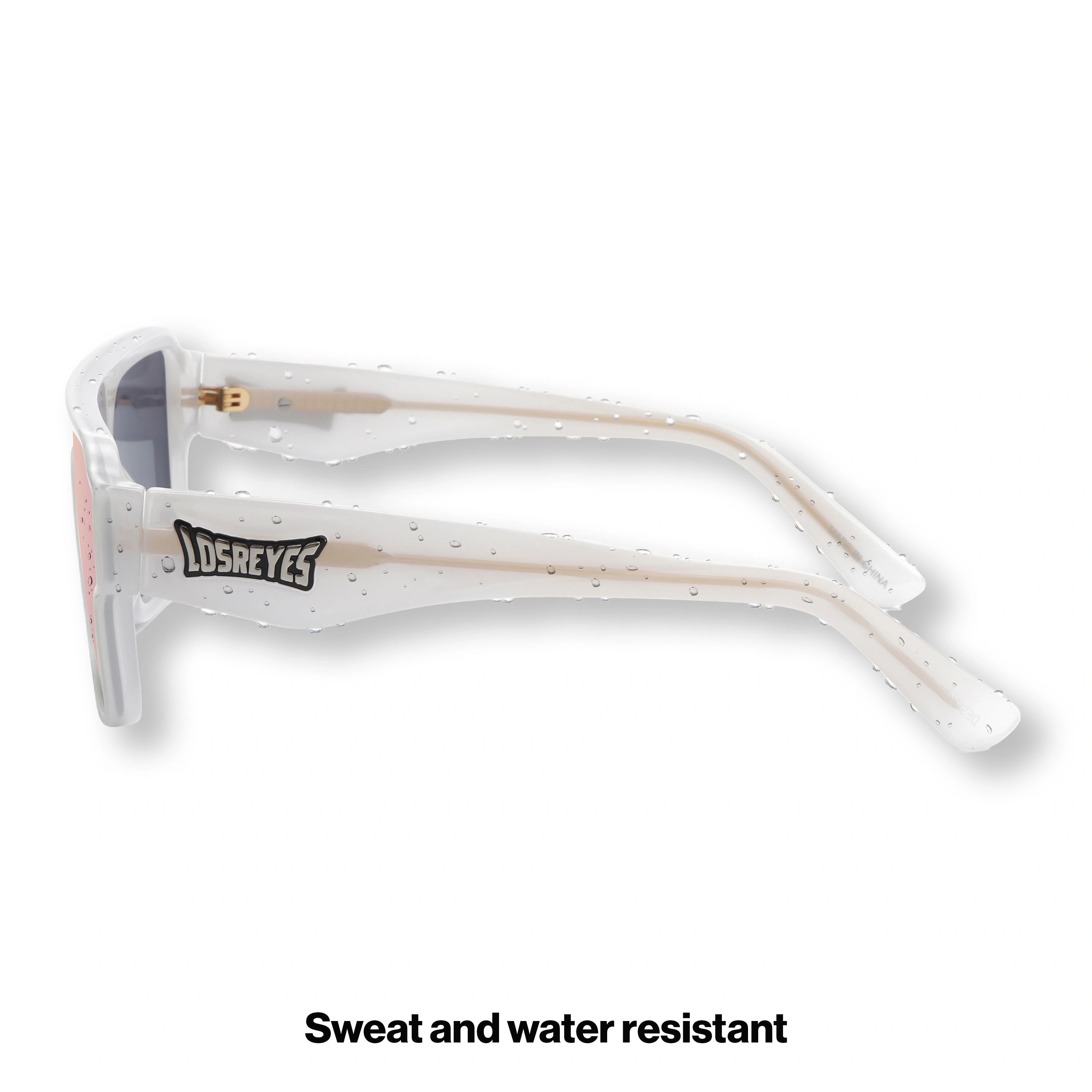 Side profile of LosReyes Omega Athena sports sunglasses showing sleek white temples, ergonomic side curve, and pink mirrored lens designed for high-intensity outdoor activity.