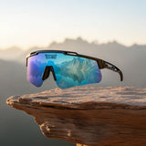 LosReyes Polarized Sunglasses with mountain reflection on a wooden surface with a mountainous background