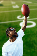 Ross500 wearing LosReyes Elevate Marshmallow sunglasses while celebrating on the field; sweat-resistant, impact-ready performance eyewear built for high-intensity sports.