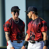 ax Clark talking with a teammate while wearing a black-and-red graphic jersey, white pants, and dark LosReyes SHOWTIME sunglasses.