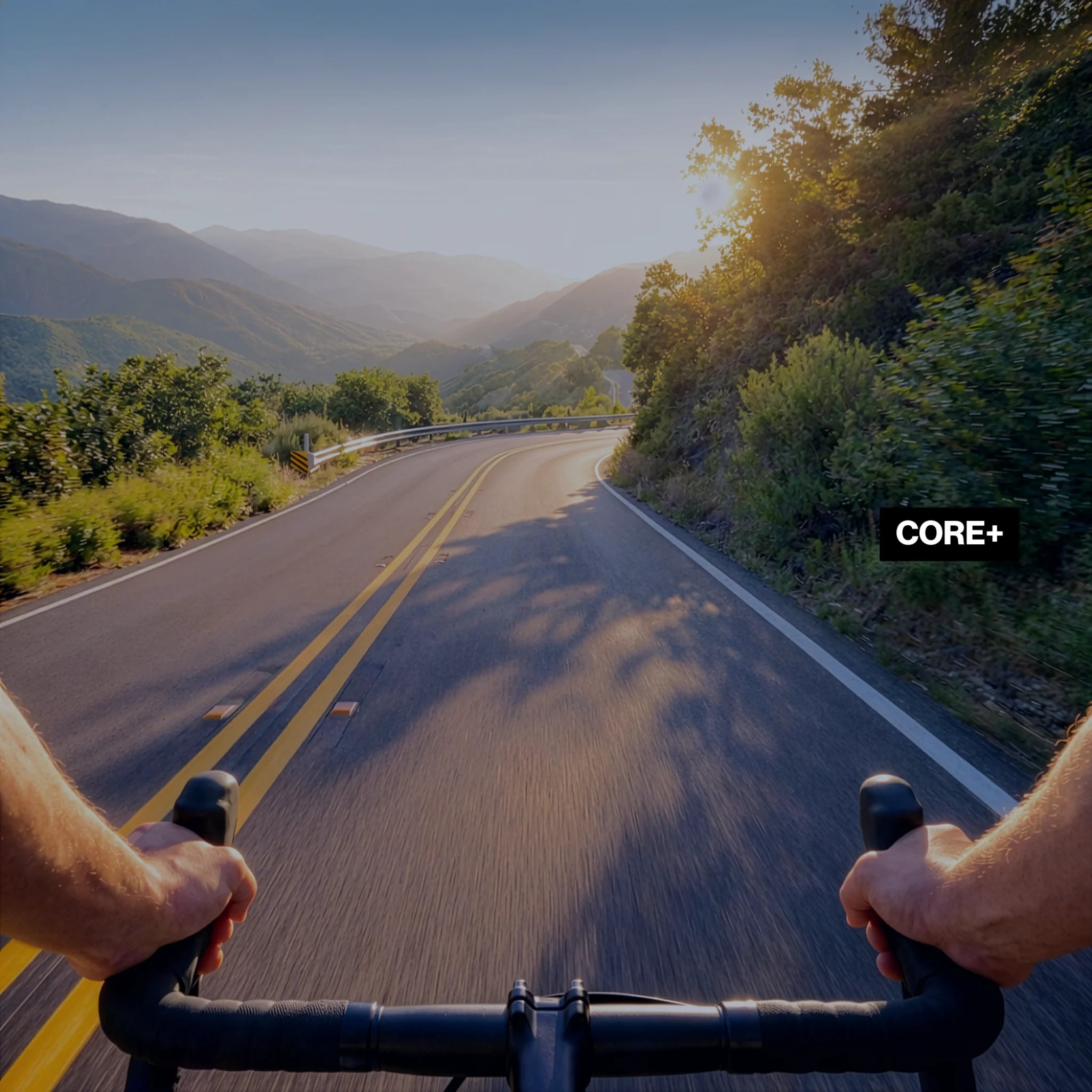 First-person view of a cyclist riding on a winding mountain road with balanced exposure, reduced glare, and enhanced detail using the LosReyes Core+ lens.