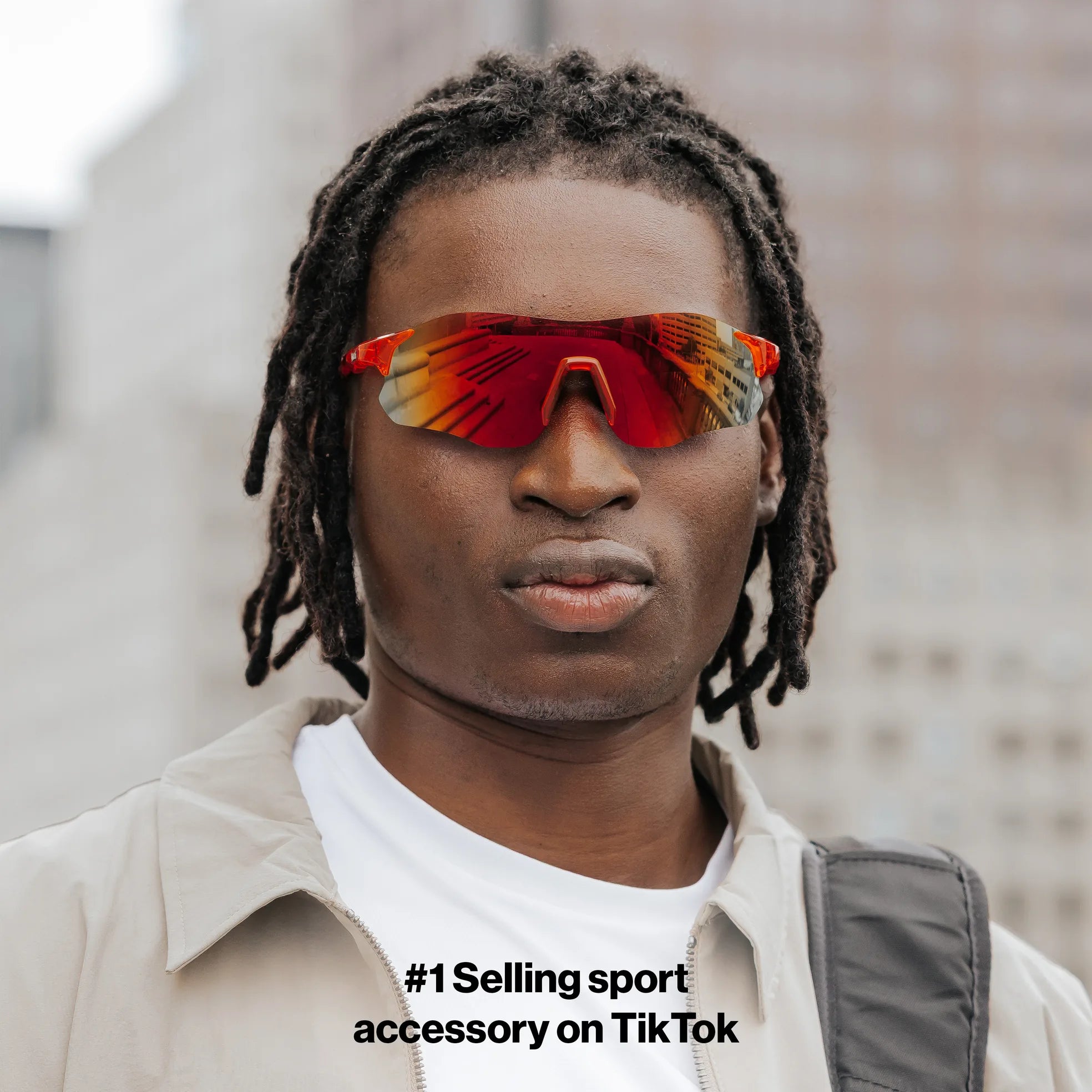 Front view of model wearing Edge Lava sunglasses with red mirrored wraparound lenses.