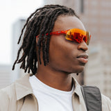 Side profile of model wearing Edge Lava sunglasses highlighting the orange-red mirrored lens finish.