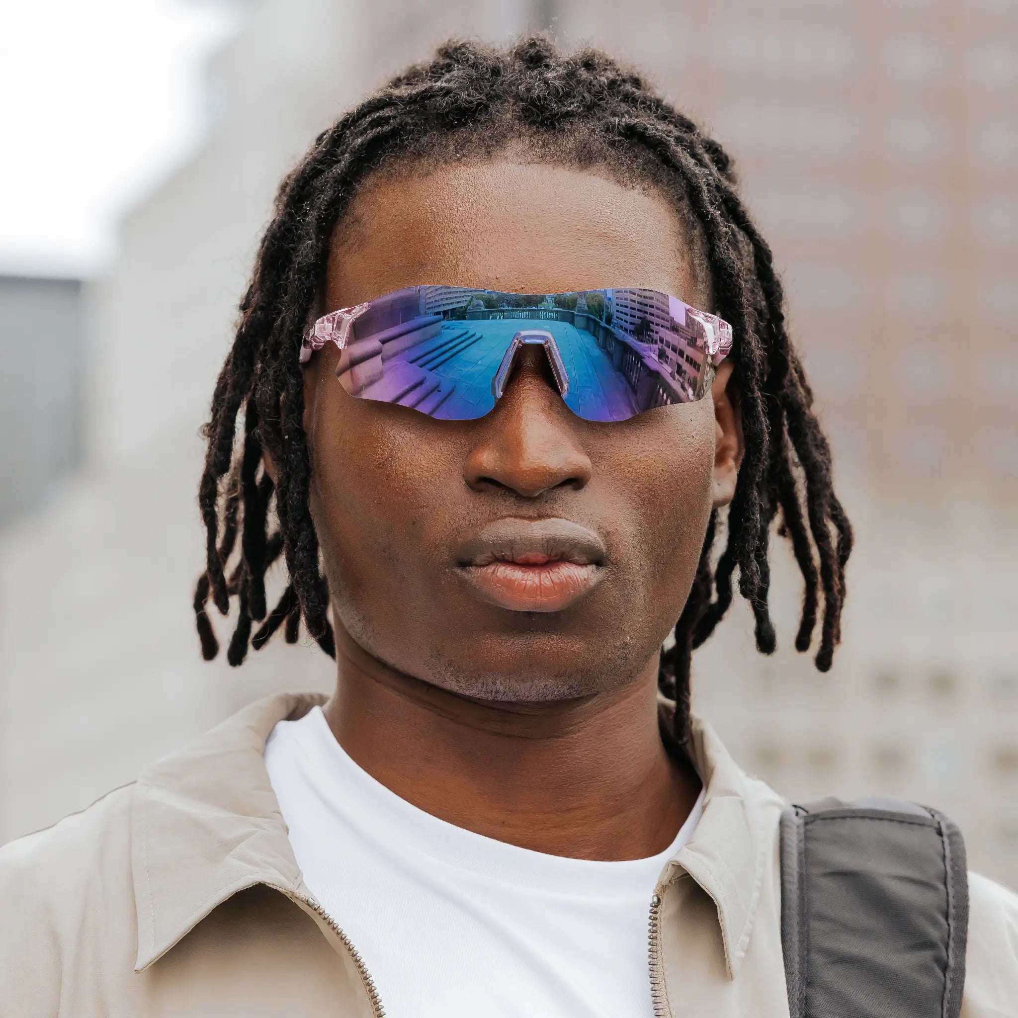 Front-facing view of model wearing Edge Royal sunglasses with purple reflective shield lenses.