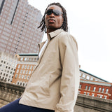 Model wearing Edge Shadow sunglasses in a city setting, lifestyle shot highlighting dark wraparound lenses.