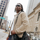 Model wearing Edge Shadow sunglasses in a city environment, full-body lifestyle shot.