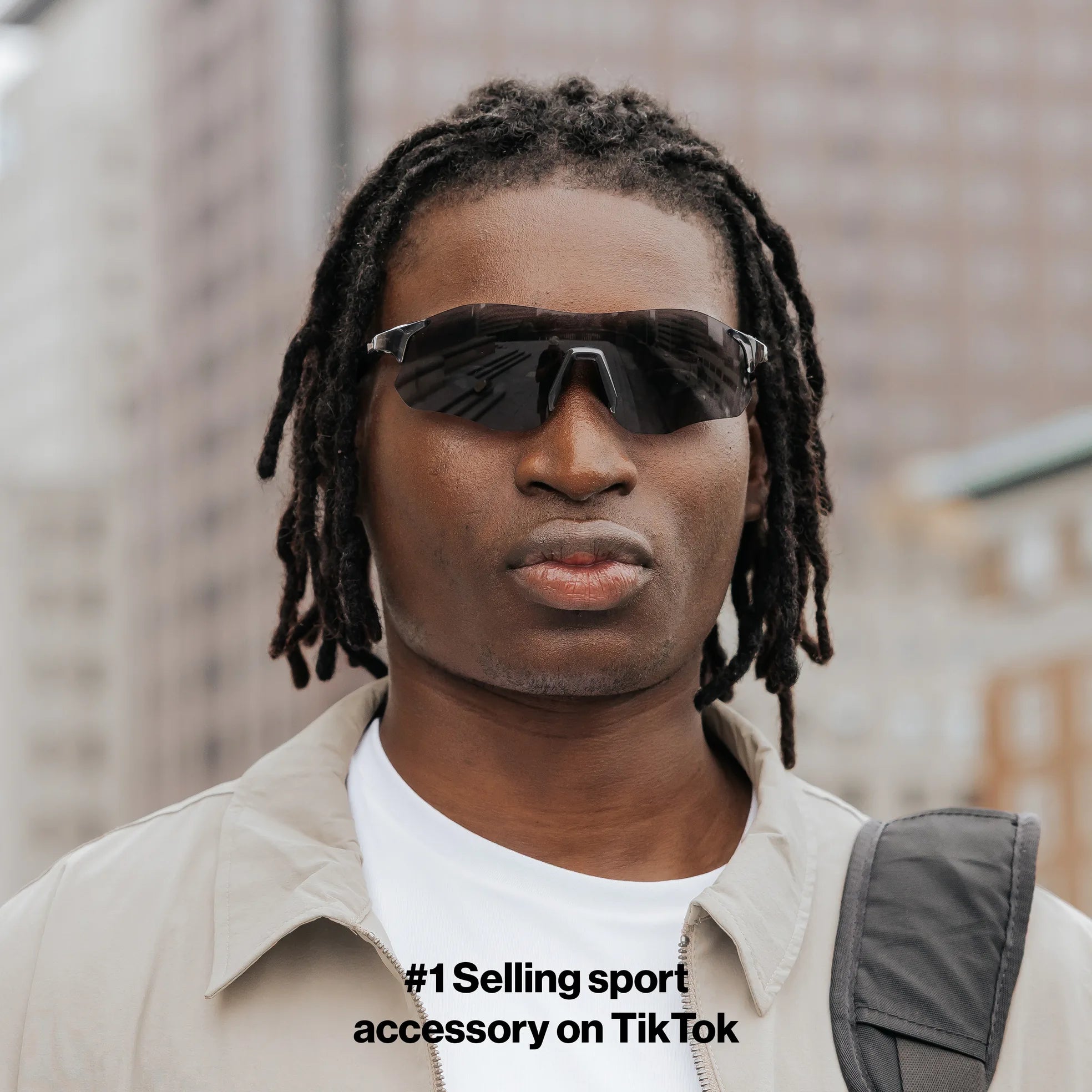Front view of model wearing Edge Shadow sunglasses with dark shield lenses.