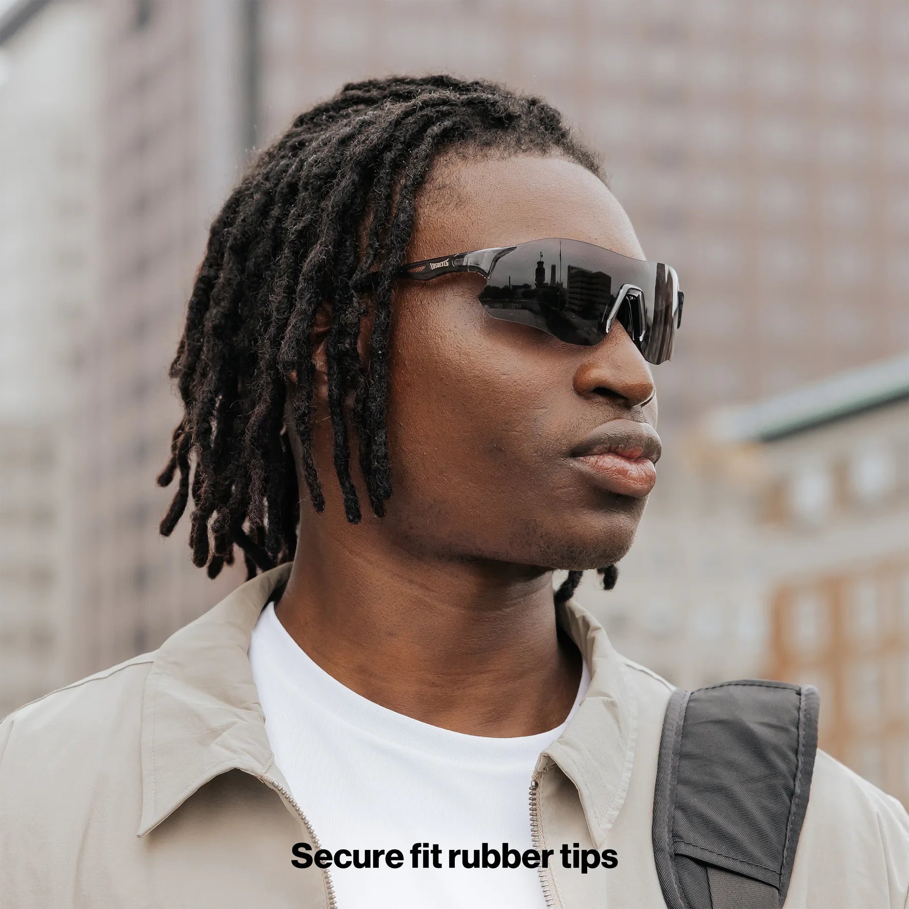 Side profile of model wearing Edge Shadow sunglasses with black wraparound lenses.