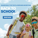 Three smiling kids in vibrant LosReyes Candy Collection sport sunglasses with backpacks under a blue sky, Back to School Sale banner