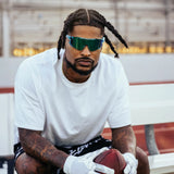 Football player Ross500 wearing LosReyes Blue Raz Elevate sports sunglasses, built for peak performance with polarized UV400 protection and feather-light TR90 frames, $48