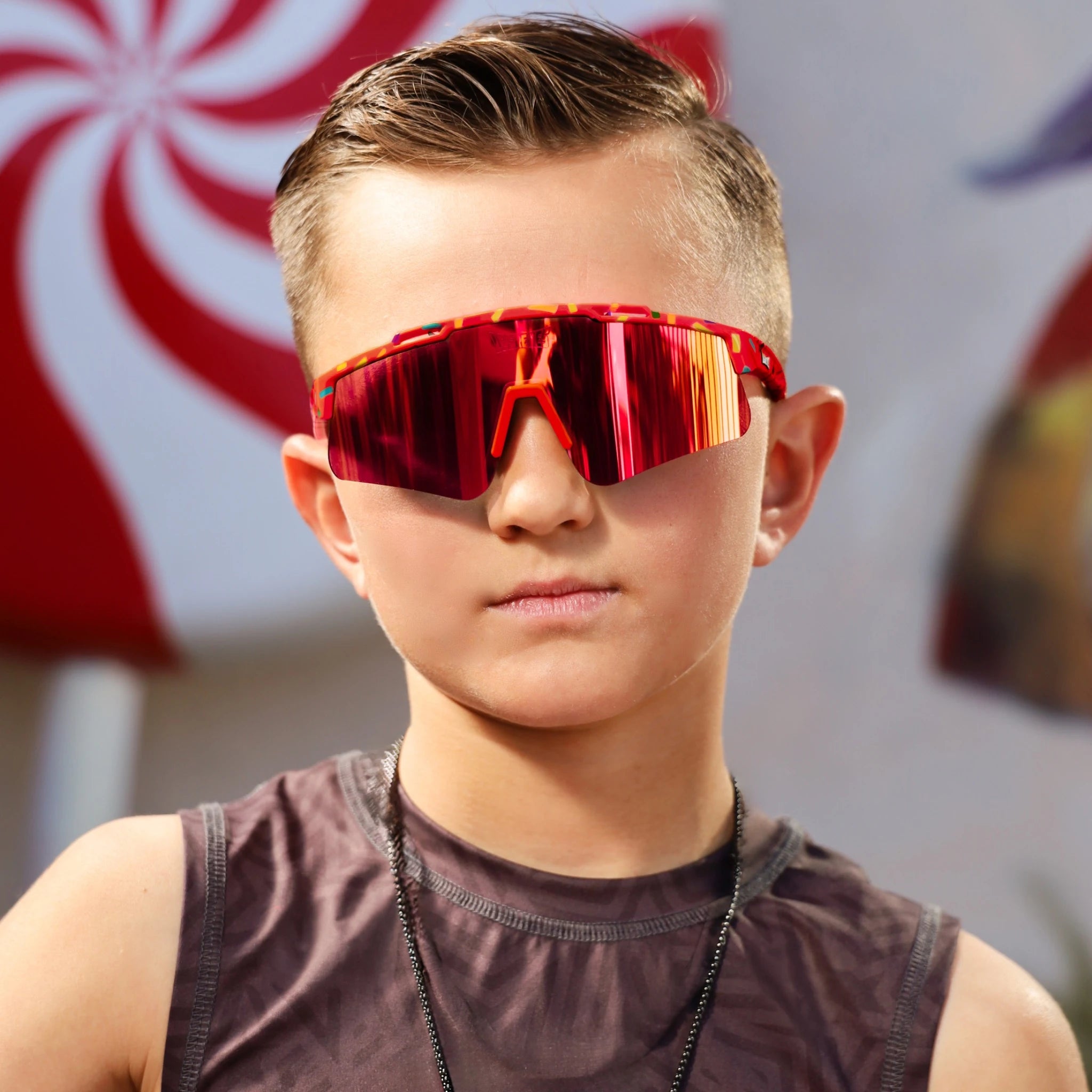 Boy wearing LosReyes Candy Collection Cream Red sunglasses with mirrored red lens, designed for lightweight comfort and everyday protection