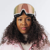 Adult wearing LosReyes Everest Cherry Blossom snow goggles lifted on forehead