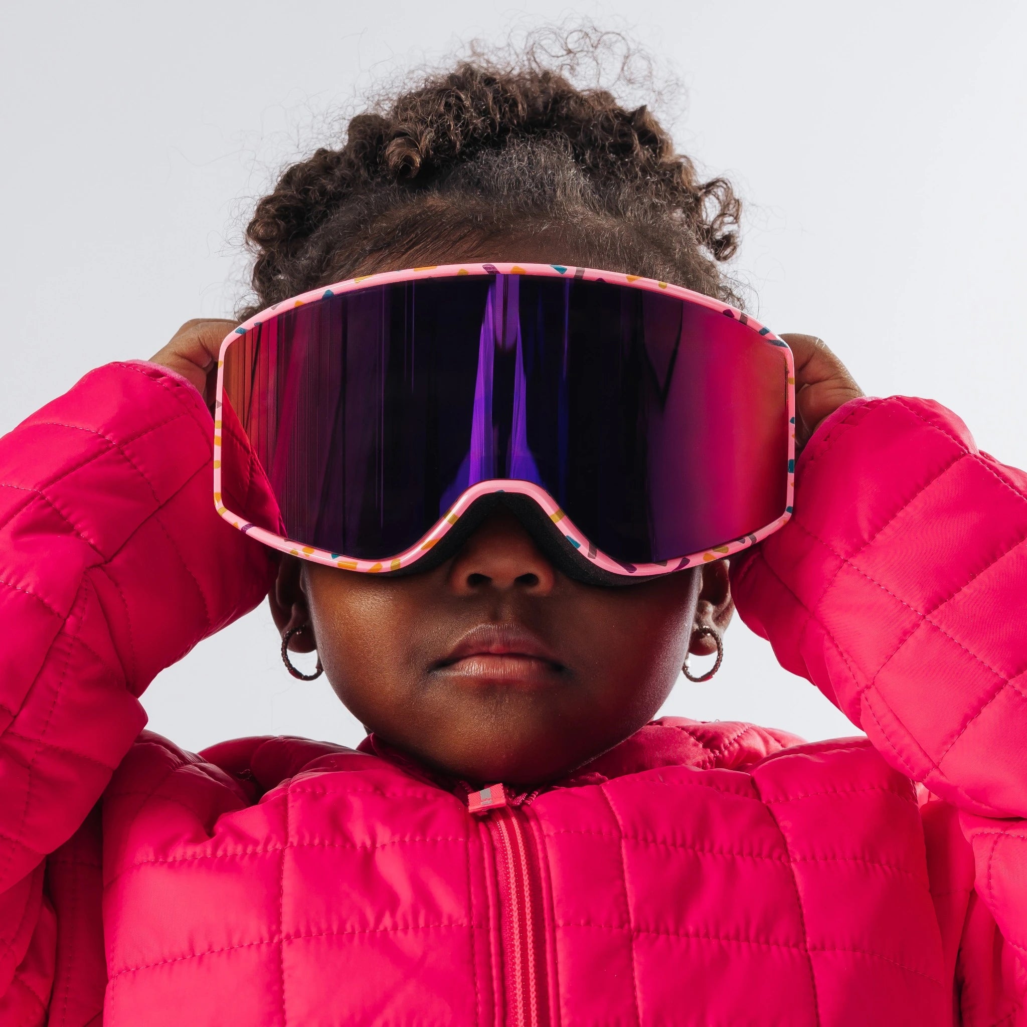 Child adjusting LosReyes Everest Cream snow goggles