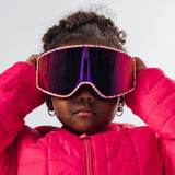 Child adjusting LosReyes Everest Cream snow goggles