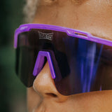 Close-up of youth wearing LosReyes Jurassic Series Brontosaurus purple sunglasses