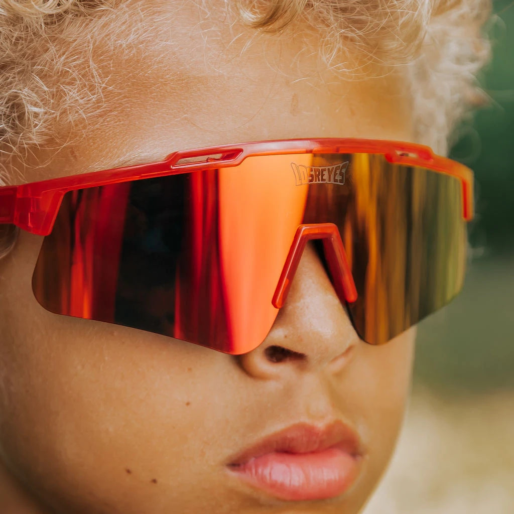 Close-up of youth wearing LosReyes Jurassic Series T-Rex red sunglasses