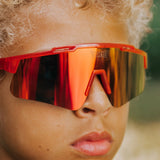 Close-up of youth wearing LosReyes Jurassic Series T-Rex red sunglasses
