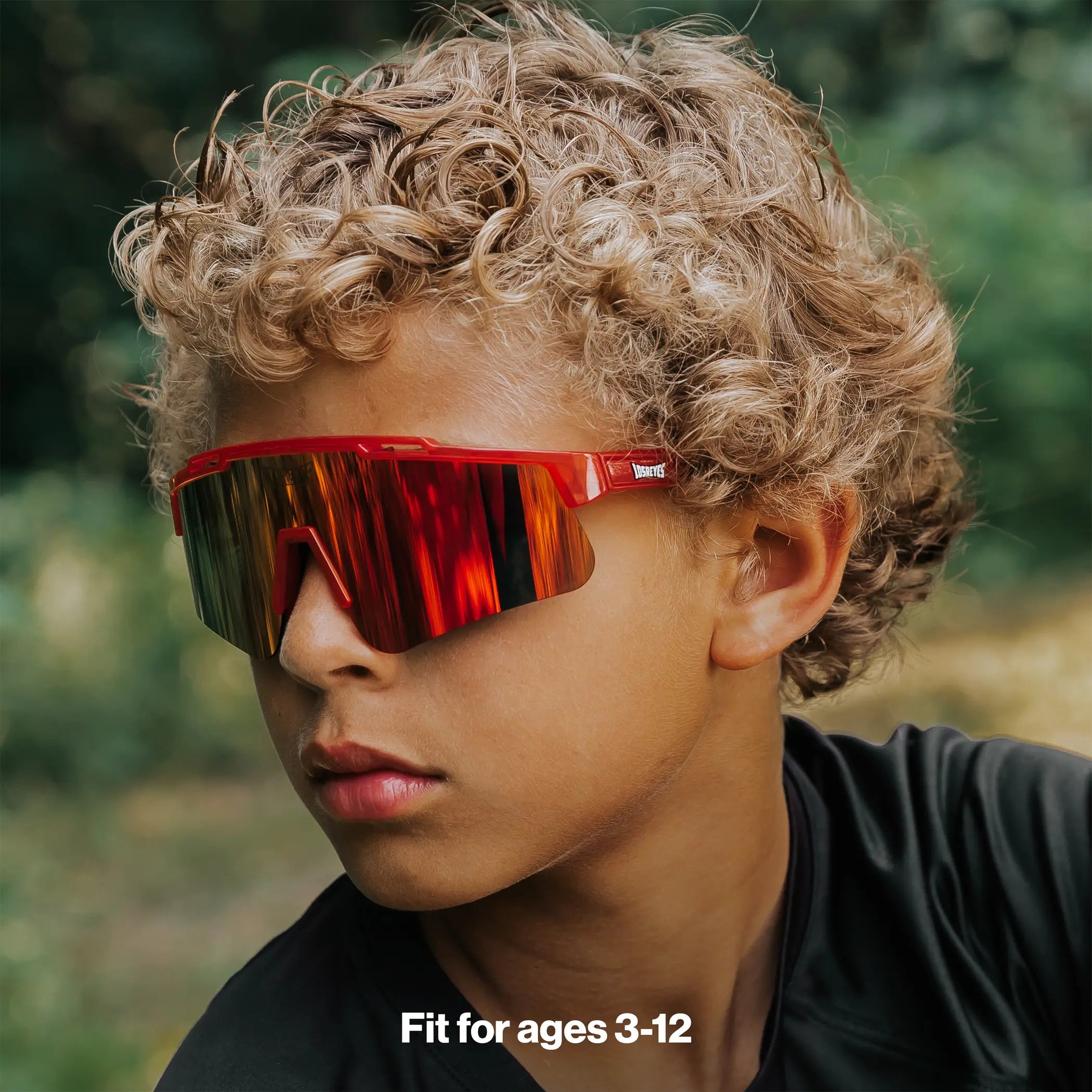 Youth wearing LosReyes Jurassic Series T-Rex red sunglasses outdoors
