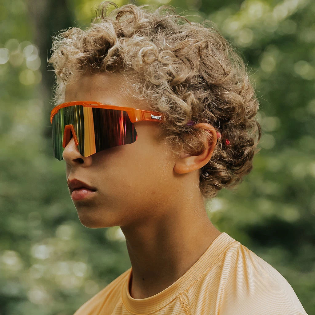Youth wearing LosReyes Jurassic Series Triceratops orange sunglasses outdoors