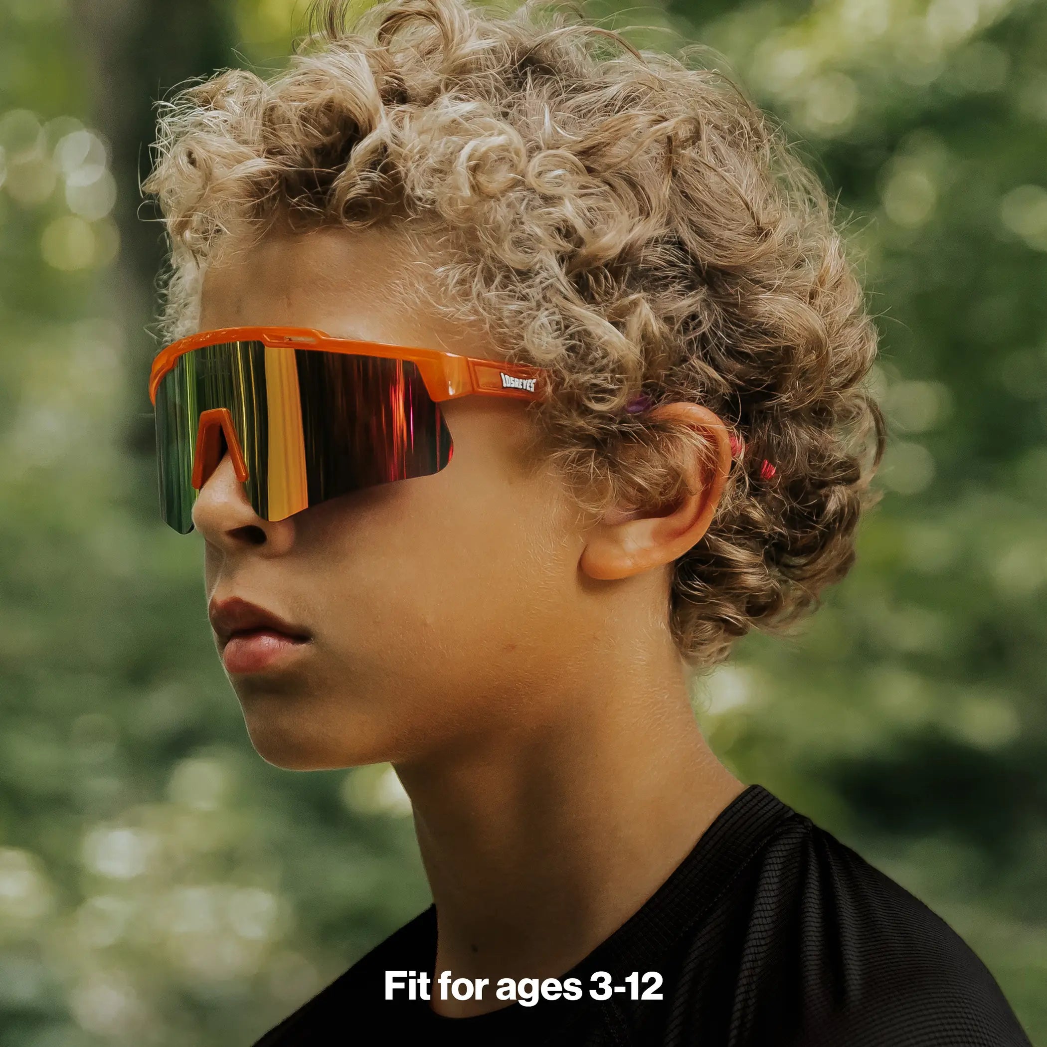 Youth wearing LosReyes Jurassic Series Triceratops orange sunglasses outdoors