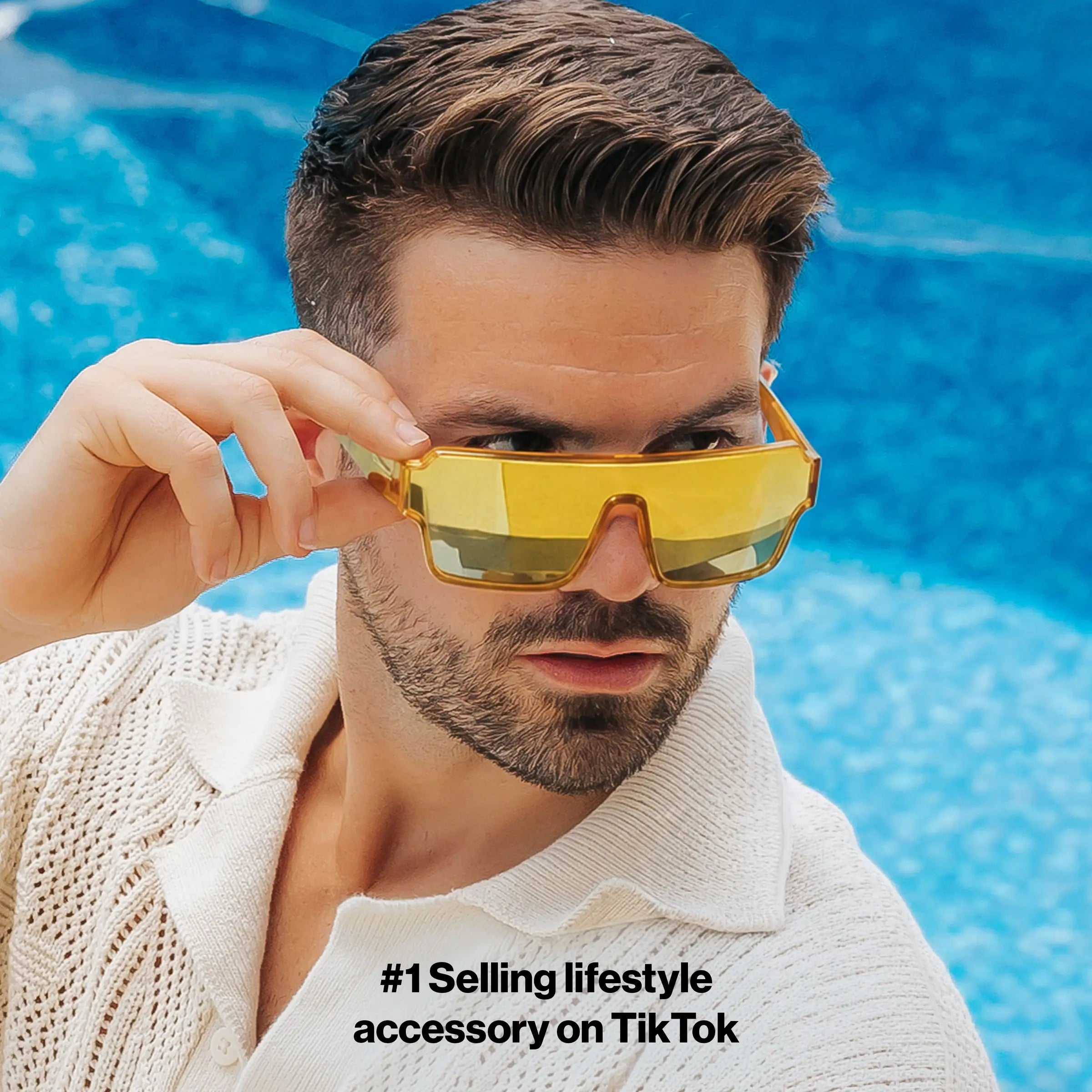 Man wearing LOSREYES Omega Apollon lifestyle sunglasses with gold frame and gold reflective mirror lens by the pool