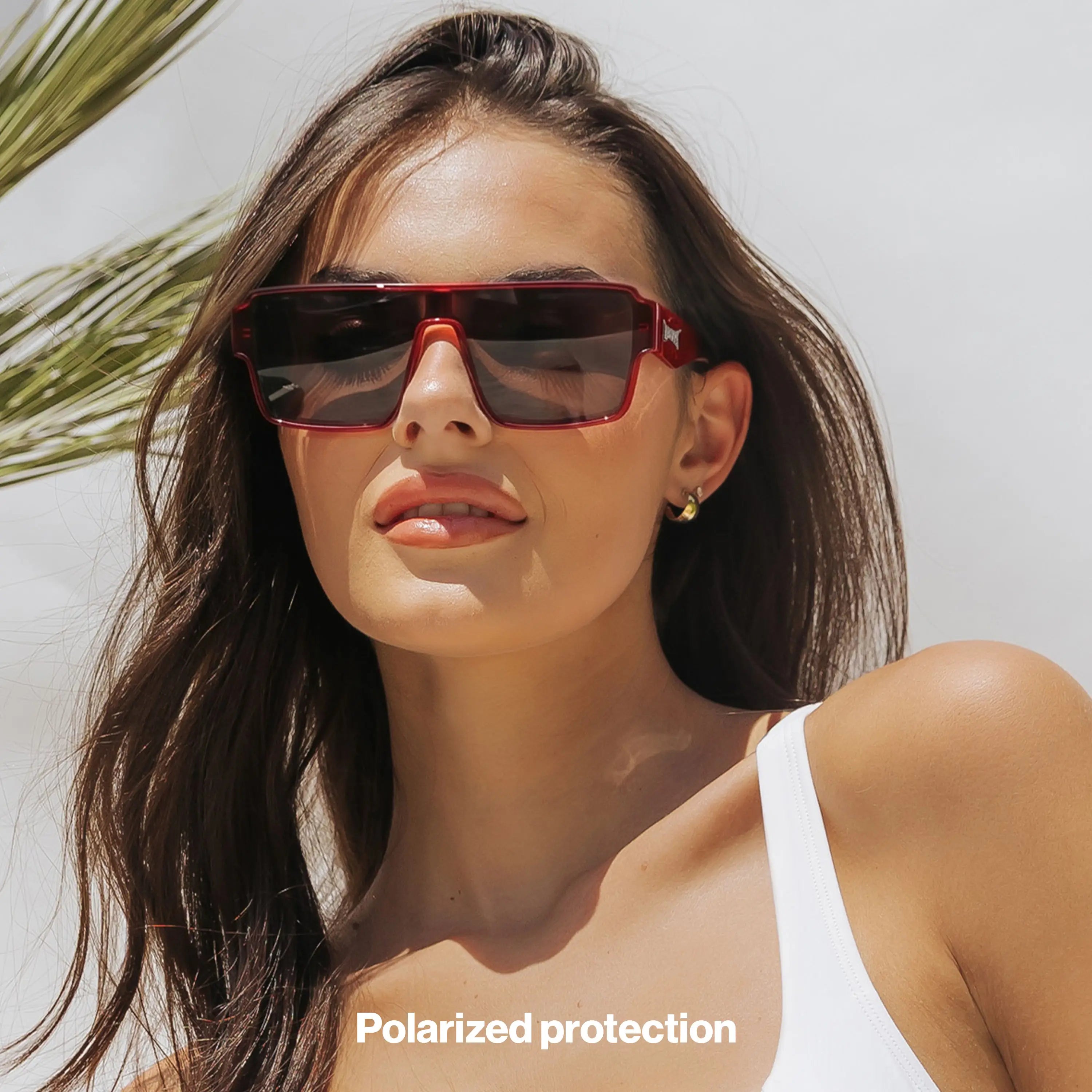 Woman wearing LOSREYES Omega Ares lifestyle sunglasses with red frame and smoke gradient lens