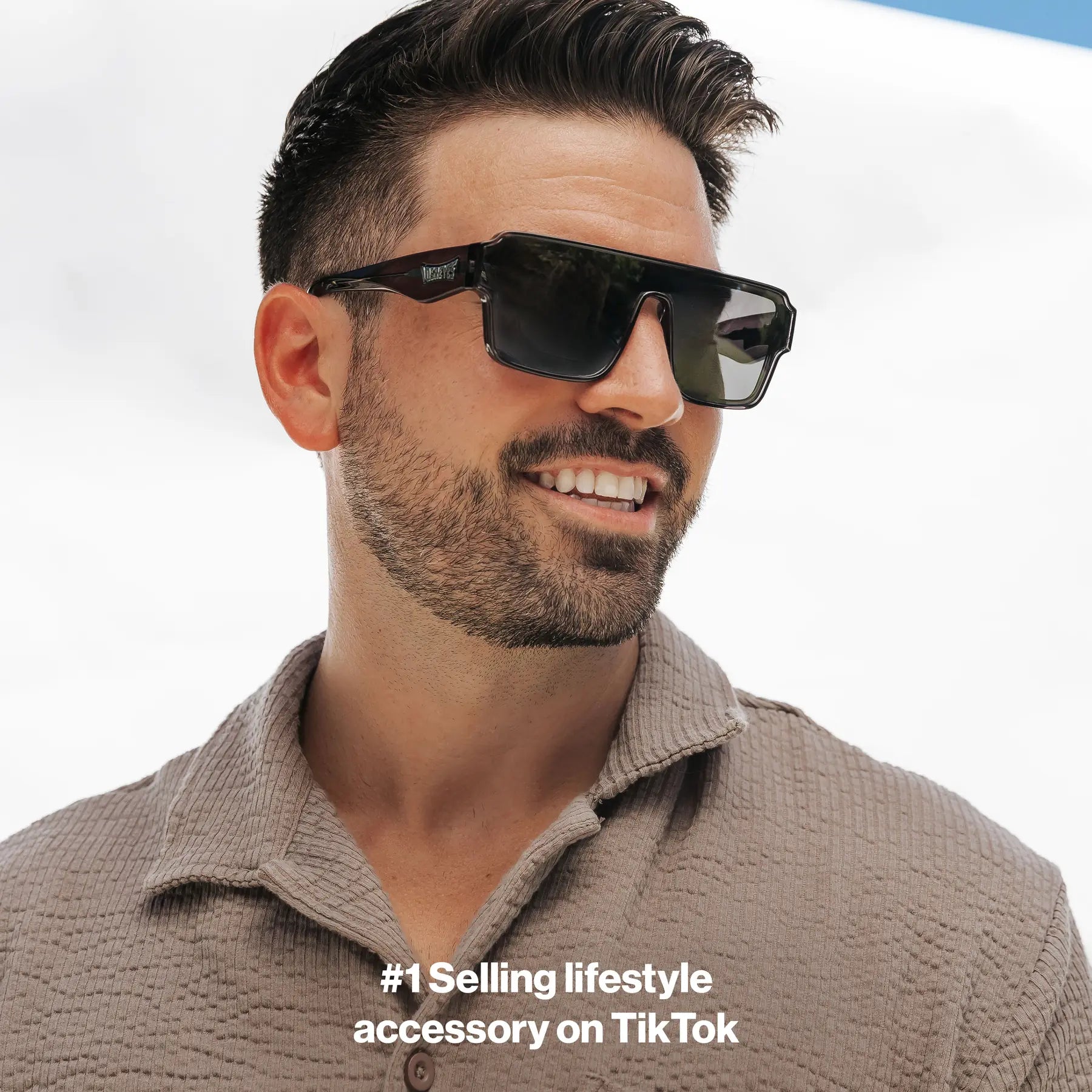 Man wearing Omega collection Hades sunglasses with a clear sky background LosReyes