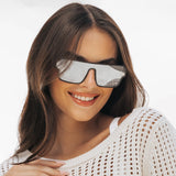 Woman wearing LOSREYES Omega Hades lifestyle sunglasses with black frame and silver reflective mirror lens