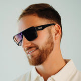 Side angle of LosReyes Omega Hades sunglasses with bold blue frame and sleek dark mirrored shield lens, combining luxury style and athletic edge for premium protection and performance.