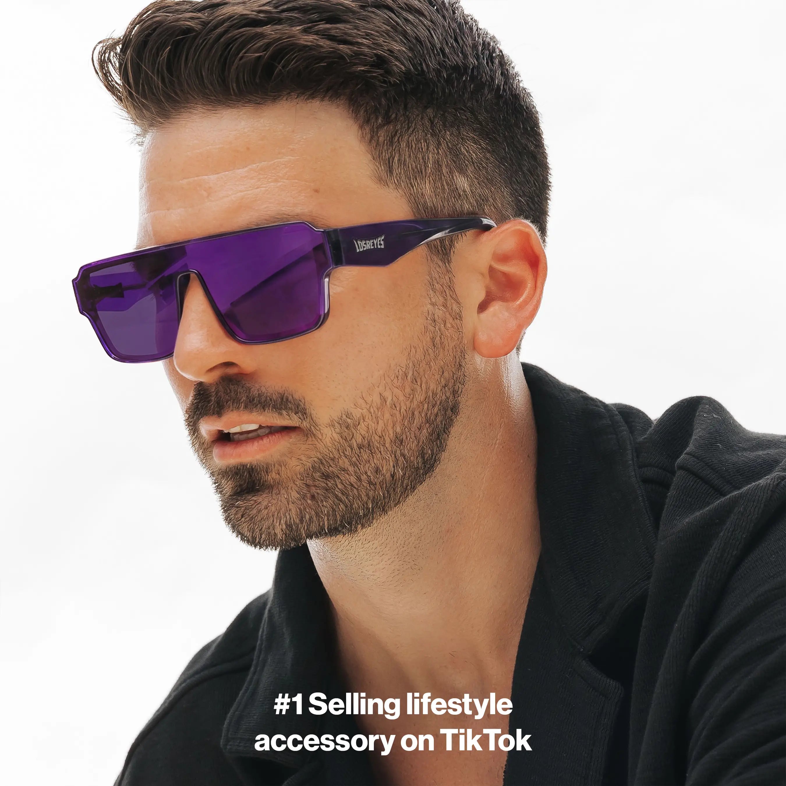 Man wearing LOSREYES Omega Zeus lifestyle sunglasses with translucent purple frame and purple reflective mirror lens