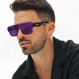 Man wearing LOSREYES Omega Zeus lifestyle sunglasses with translucent purple frame and purple reflective mirror lens