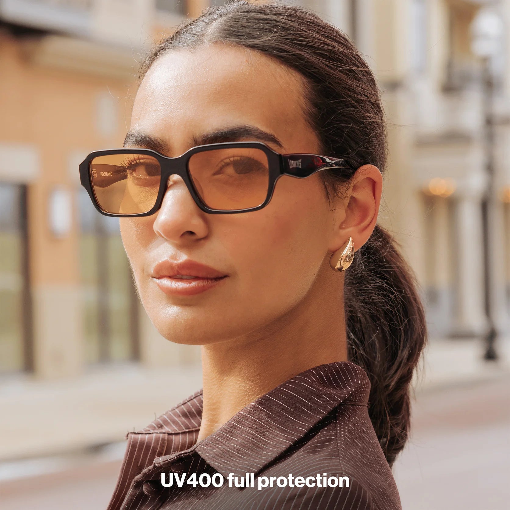 Woman wearing LosReyes Opus Positano black sunglasses with orange lenses – luxury fashion eyewear