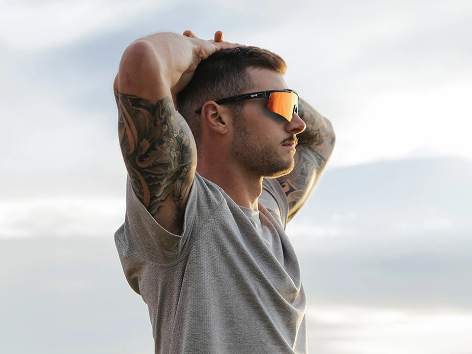 Man wearing polarized wraparound sport sunglasses outdoors by LosReyes