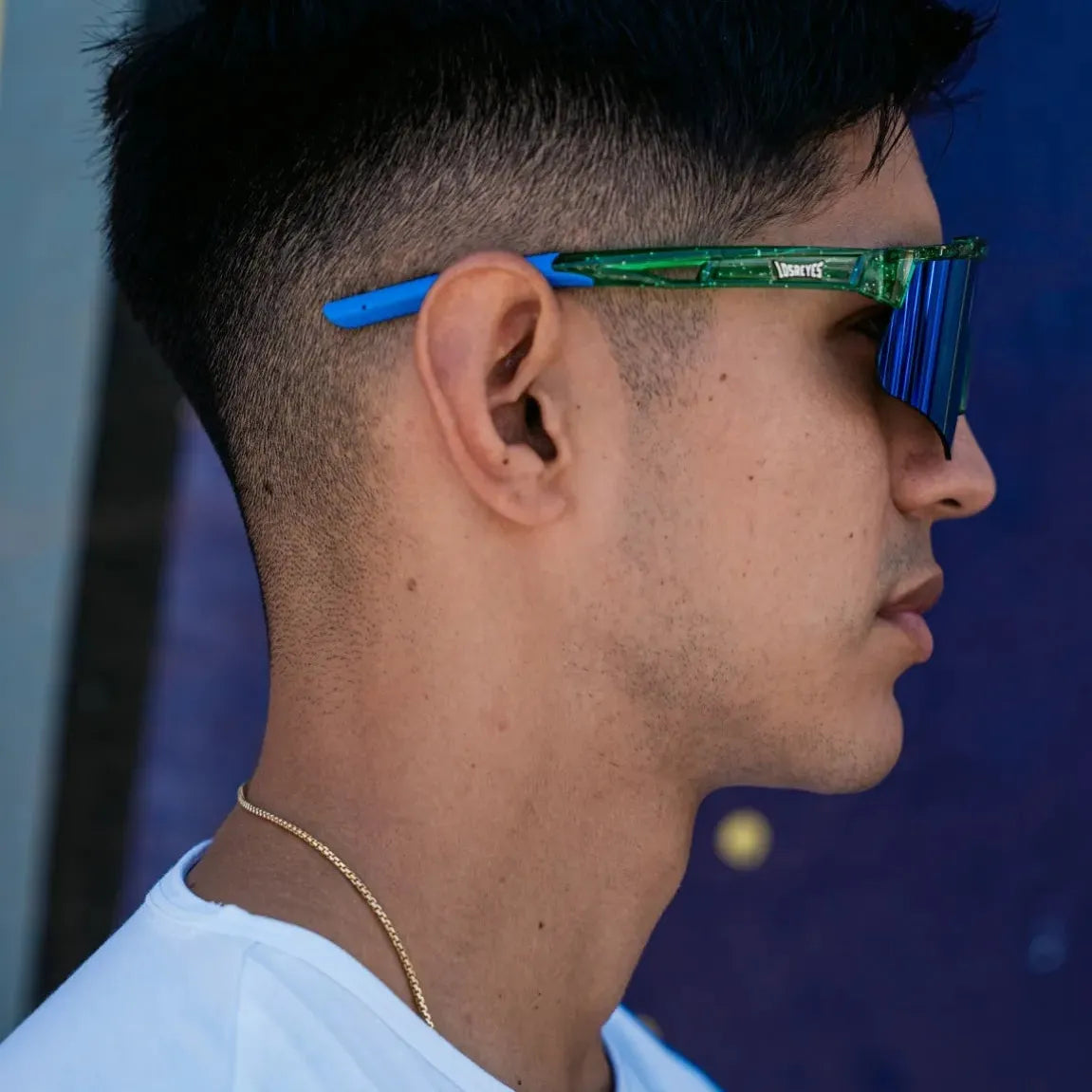  Lifestyle side profile of LosReyes Prime Galaxy Earth mirrored athletic sunglasses with green-blue lens and curved fit, ideal for baseball, training, and everyday active wear.