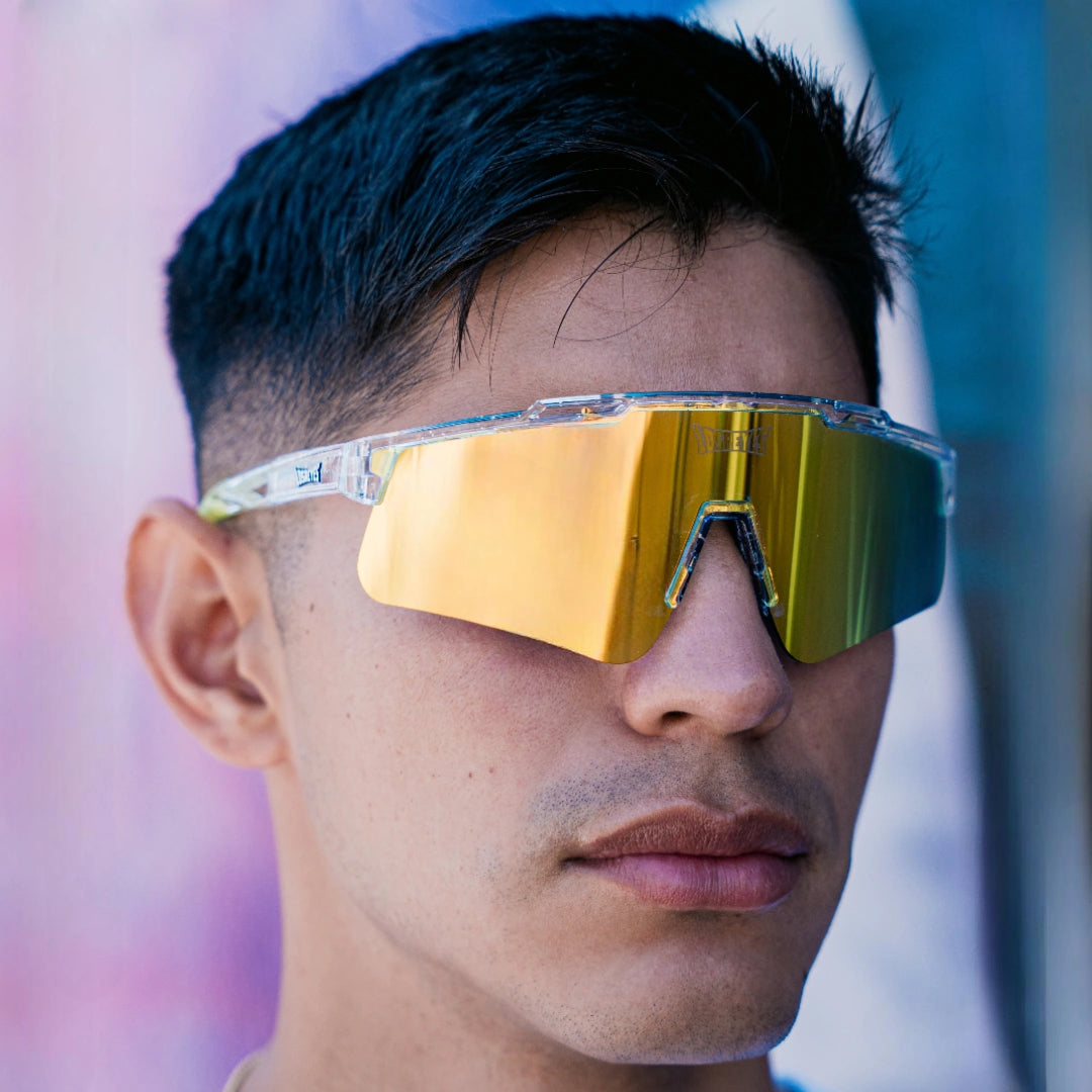 Lifestyle close-up of LosReyes Prime Galaxy Saturn mirrored sports sunglasses on model, showing full shield coverage and high-performance wrap for training or competition.