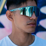 Close-up of LosReyes Prime Galaxy Uranus mirrored sports sunglasses on model, with curved blue shield lens and clear frame delivering elite protection and athletic edge.