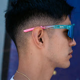 Side lifestyle view of LosReyes Prime Galaxy Vice sunglasses with cosmic blue lenses and gradient pink arms, designed for high-impact athletic use.