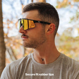 Man wearing LosReyes PRIME Polarized sunglasses with black frame and orange mirror lens, side profile view with secure-fit rubber tips