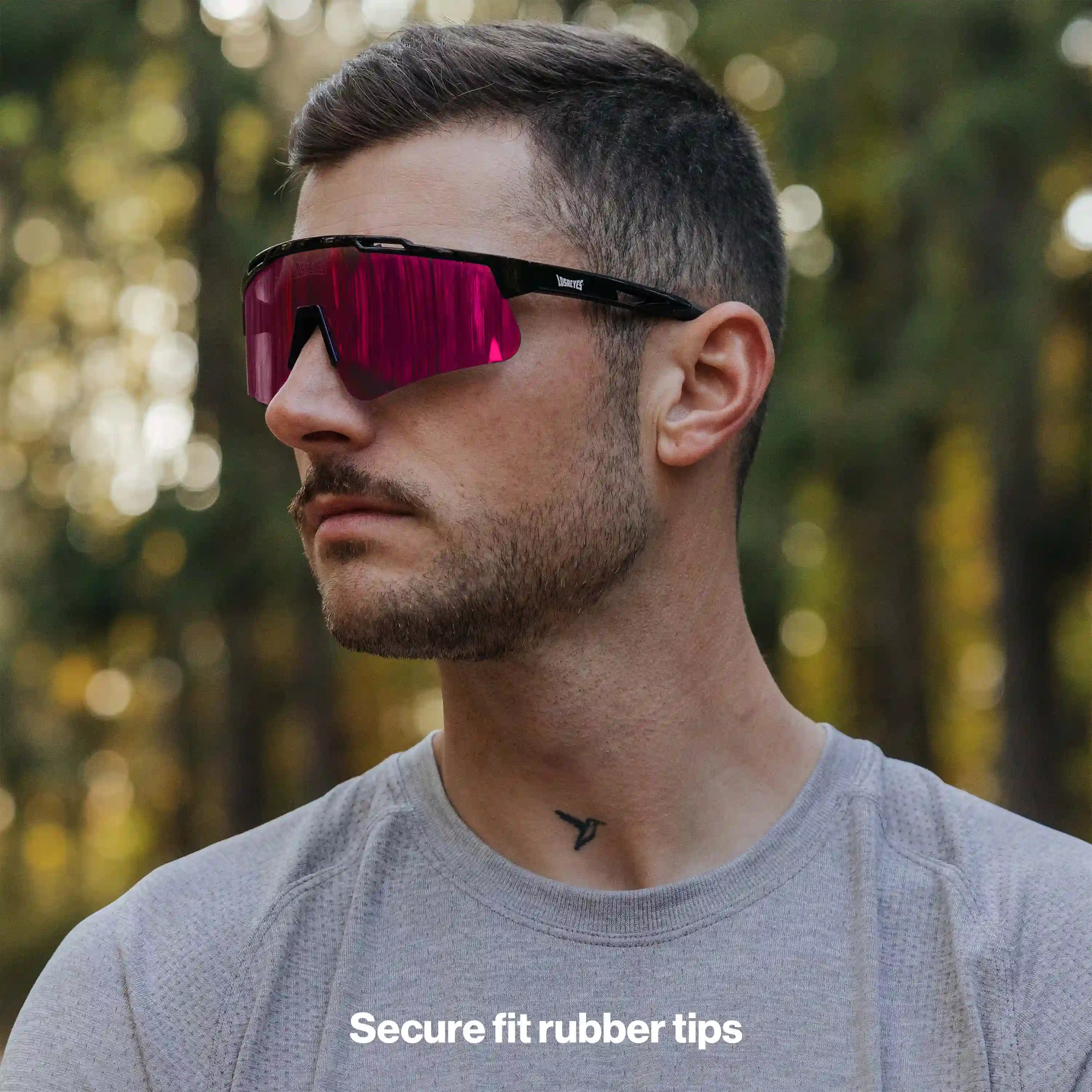 Man wearing LosReyes PRIME Polarized sunglasses with black frame and pink mirror lens, side profile view with secure-fit rubber tips