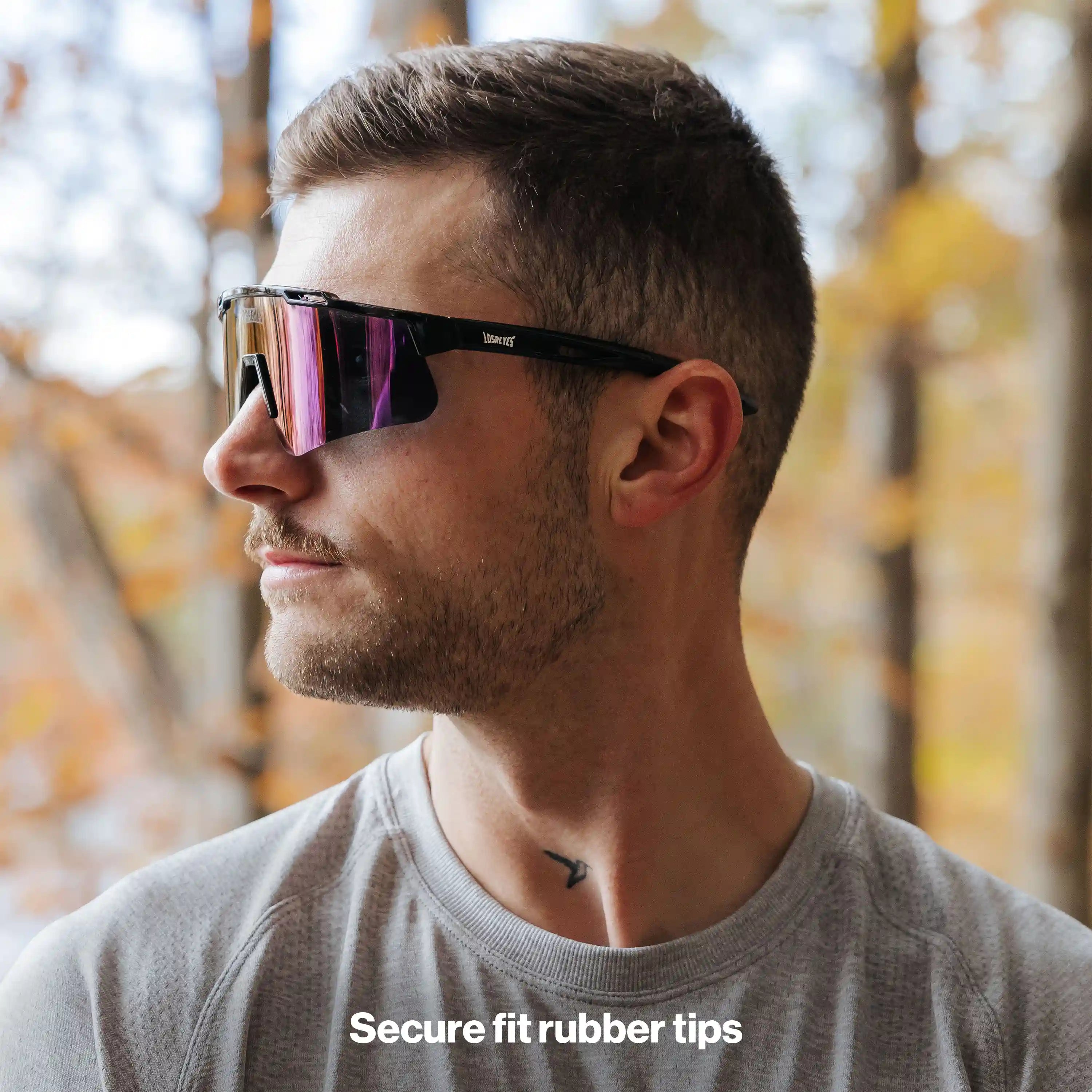 Man wearing LosReyes PRIME Polarized sunglasses with black frame and purple mirror lens, side profile view with secure-fit rubber tips