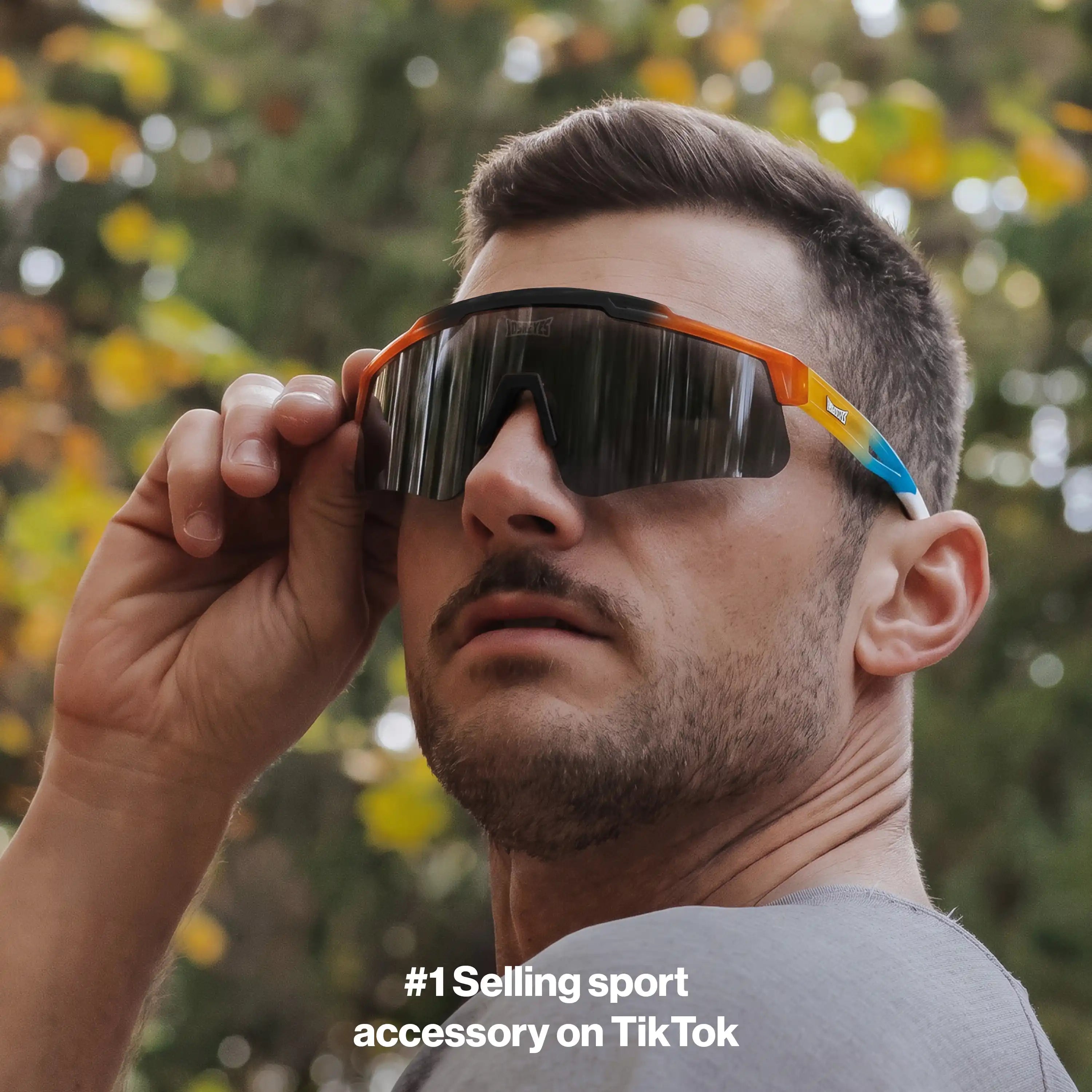 Man outdoors wearing LosReyes Prime Summer Drop sunglasses in sunset gradient with smoke lens