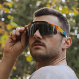 Man outdoors wearing LosReyes Prime Summer Drop sunglasses in sunset gradient with smoke lens