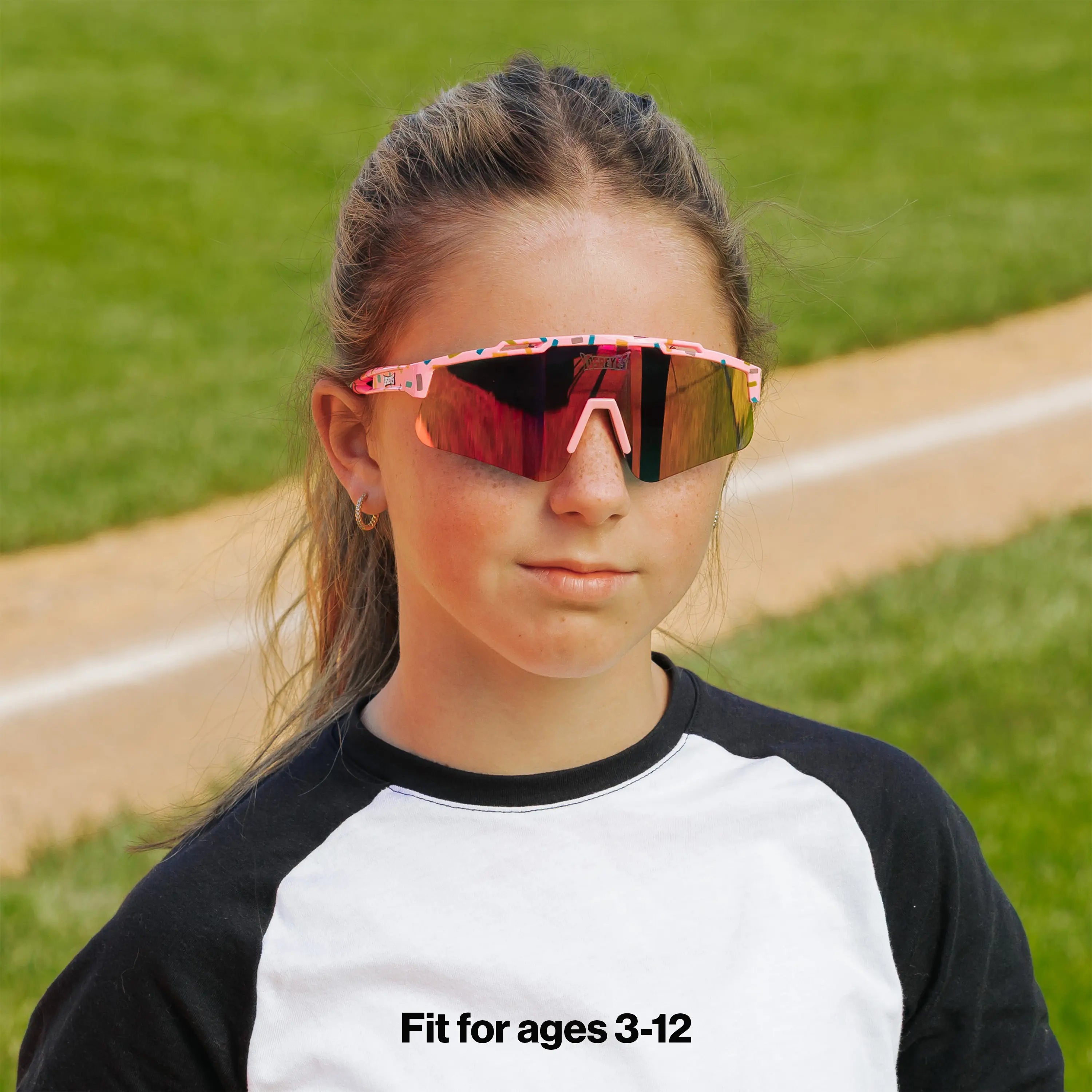 LosReyes PrimeYouth Candy Collection "Cream Pink" youth sunglasses with UV400 protection on baseball field