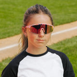 LosReyes PrimeYouth Candy Collection "Cream Pink" youth sunglasses with UV400 protection on baseball field
