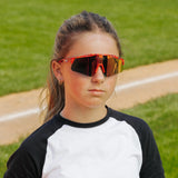 LosReyes PrimeYouth Candy Collection "Cream Red" youth sunglasses with UV400 protection on baseball field