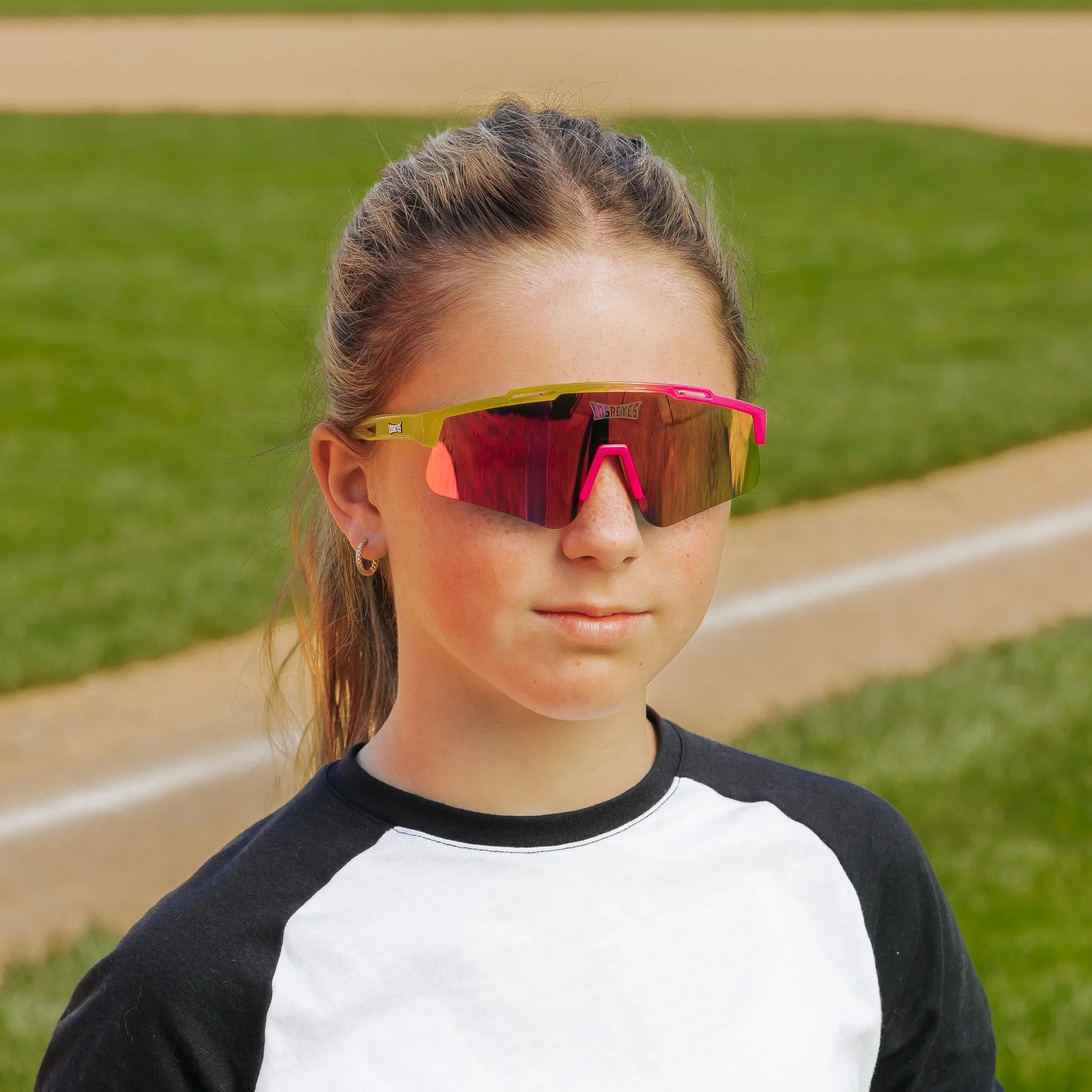 LosReyes PrimeYouth Candy Collection "Strawberry Banana Split" youth sunglasses with UV400 protection on baseball field